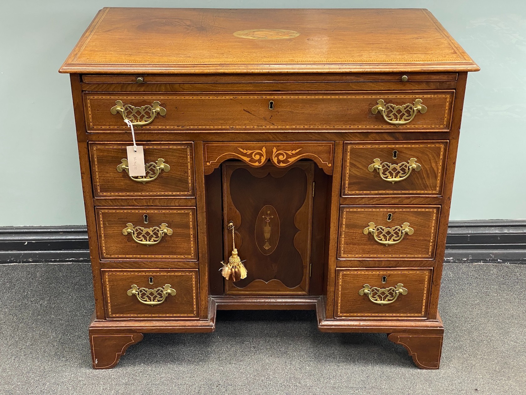 A George III later marquetry inlaid mahogany kneehole desk fitted slide, width 87cm, depth 50cm, height 79cm